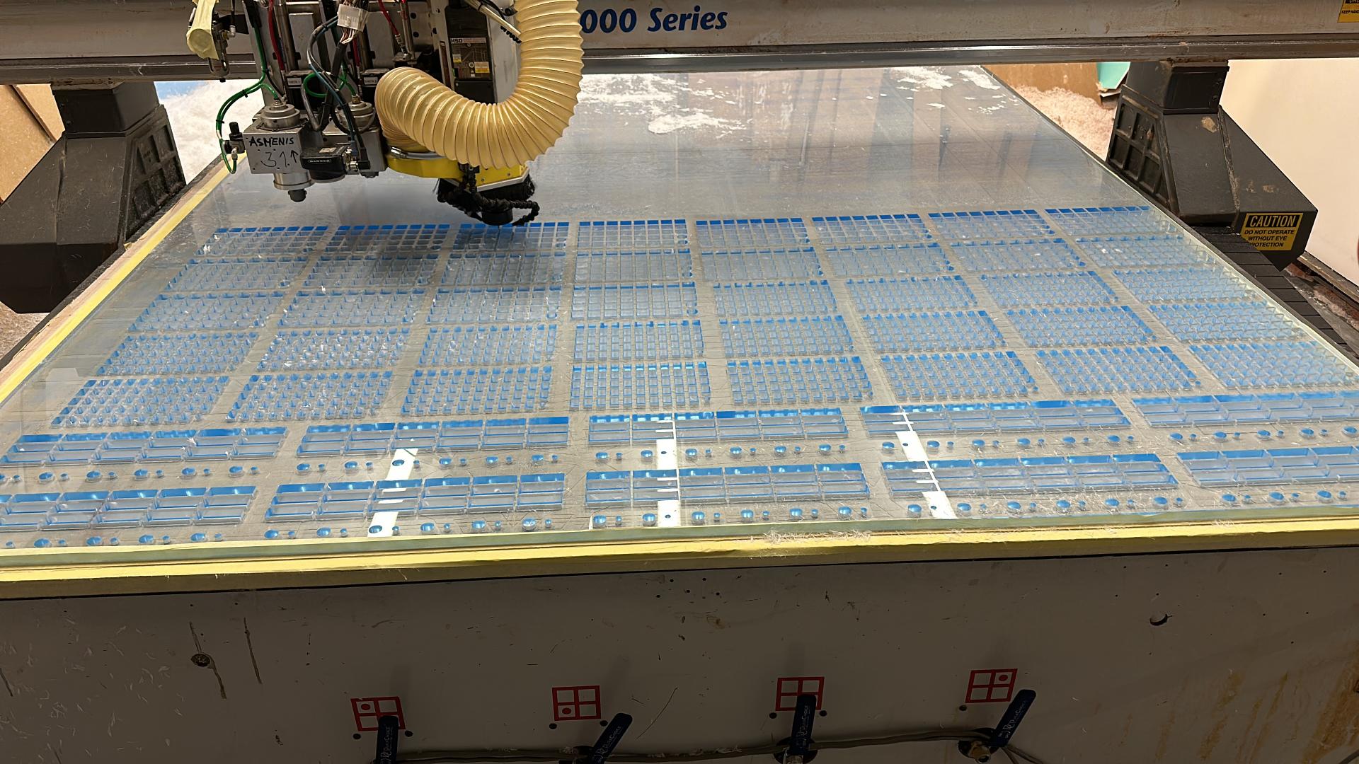 Laser-cut acrylic screens and CNC-milled fluted wood panels